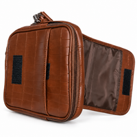 Brown crocodile-textured sling bag front detail
