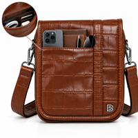 Brown crocodile-textured sling bag front view